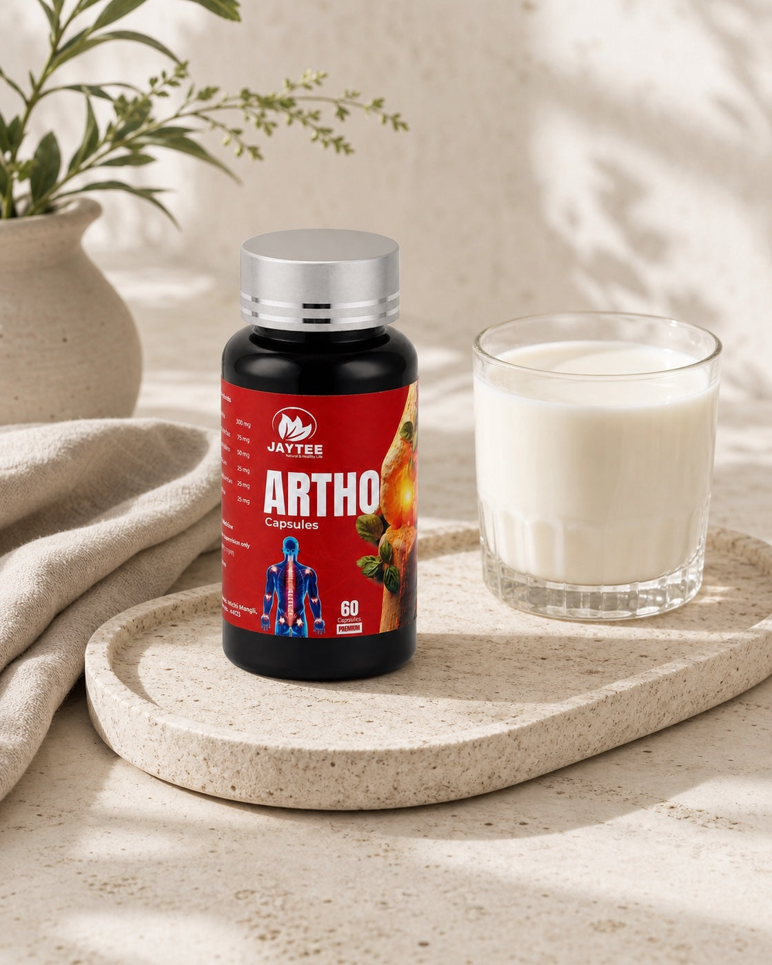 Closed Arthro Capsules 60-capsule bottle beside a glass of water in a calm daily-routine still life