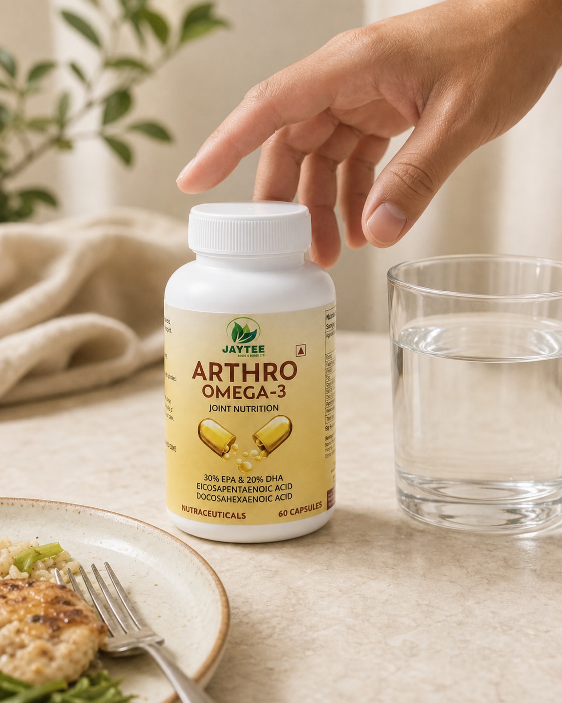 Adult hand reaching for a closed Arthro Omega 3 bottle beside a glass of water after a meal