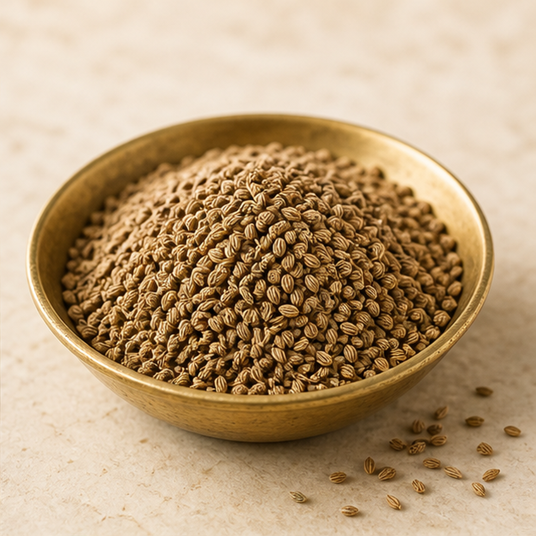 Whole Ajwain seeds in a brass bowl in an editorial ingredient study