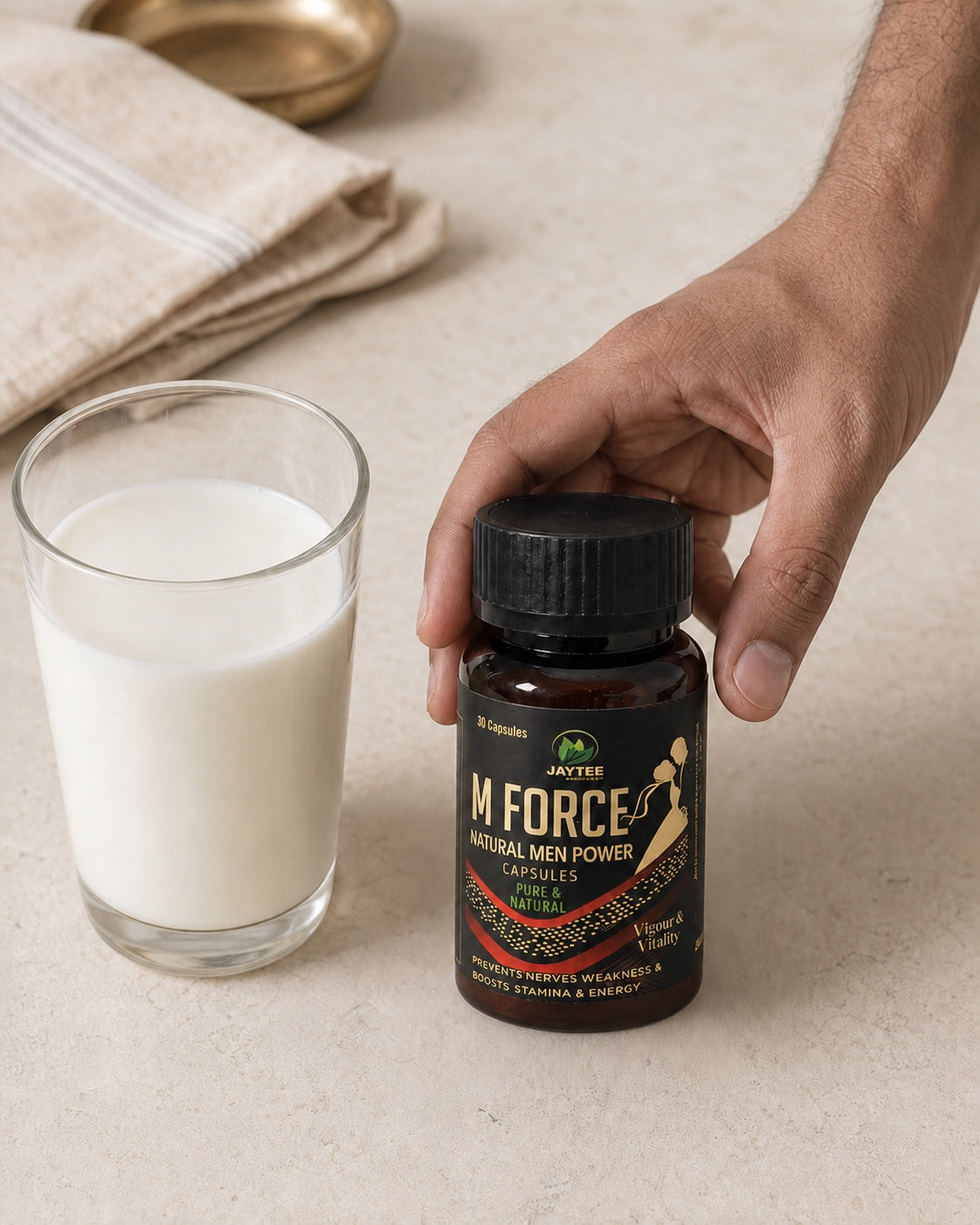 Adult hand positioning a closed M Force 30-capsule bottle beside a glass of milk