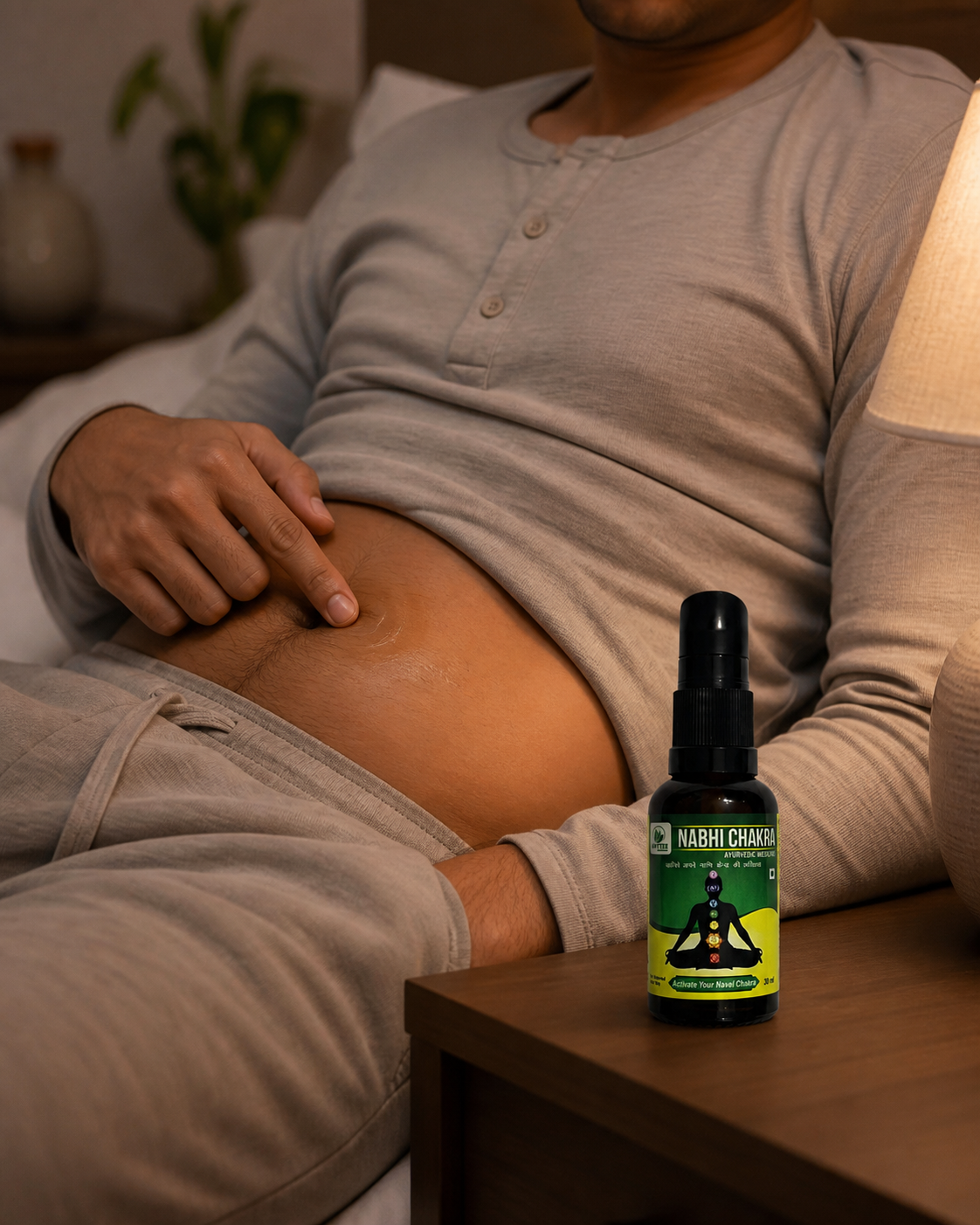 Adult applying Nabhi Chakra gently at navel level with the 30 ml bottle standing nearby