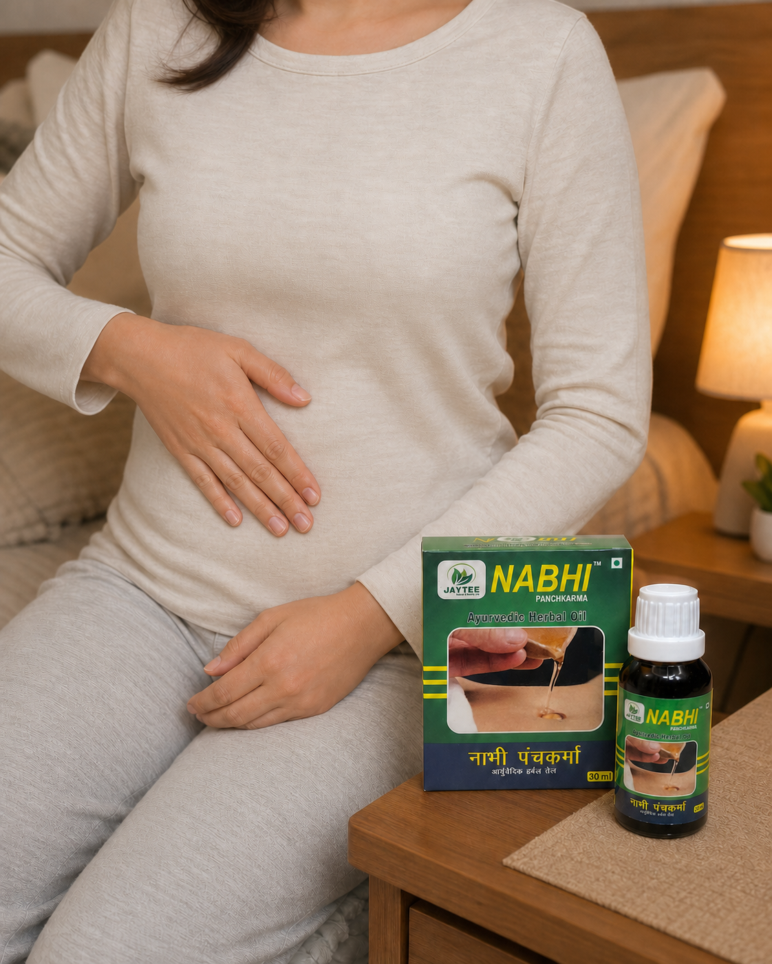 Fully clothed adult gently massaging at navel level with a closed Nabhi Panchkarma bottle nearby